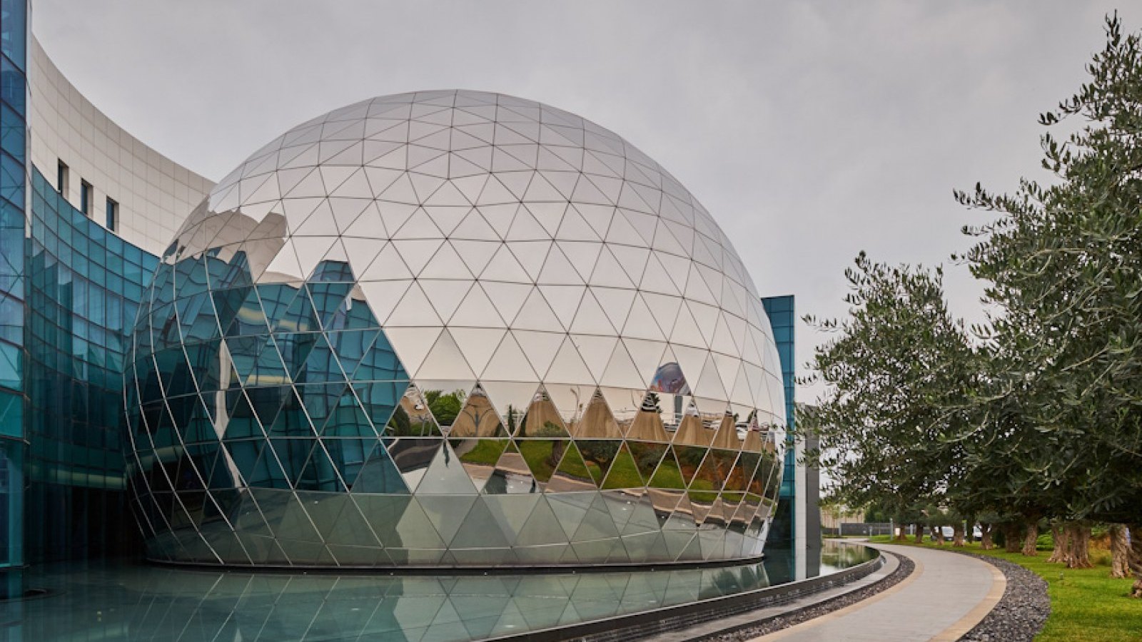 The domed training centre on the Middle East Airlines campus in Beirut, its faceted cladding reflected in the pool in front of it.